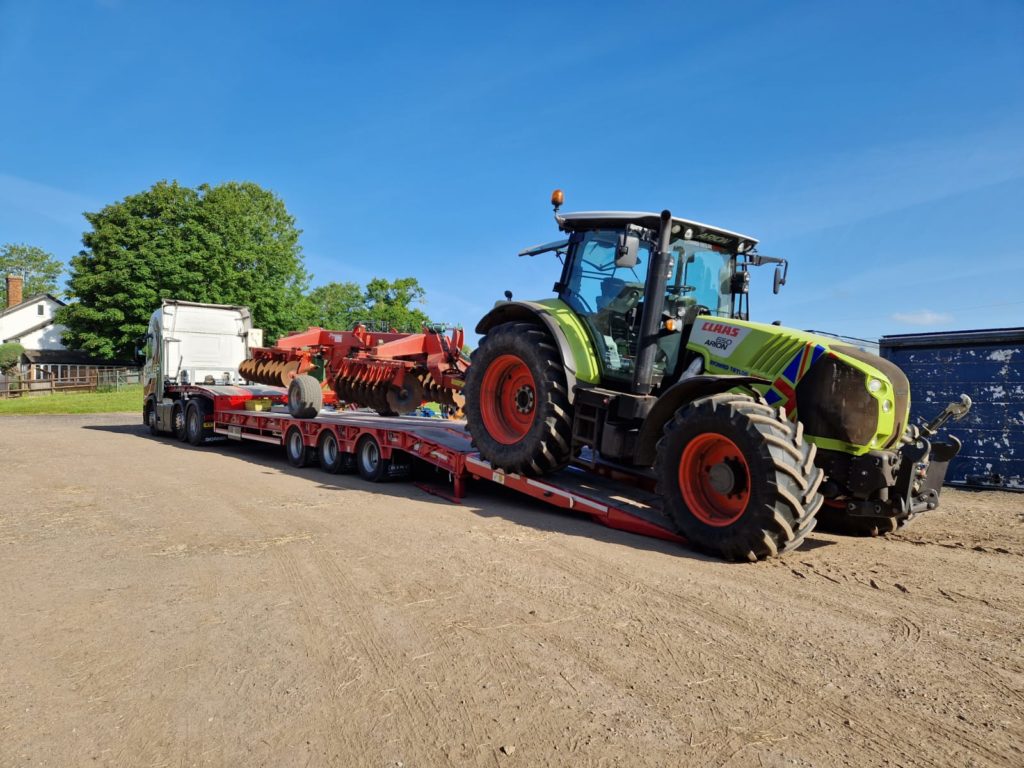 Glover tractor unloading transported tractor