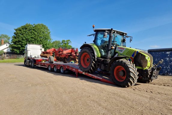 Glover tractor unloading transported tractor