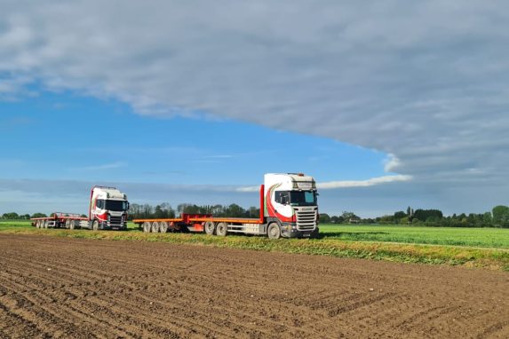 Two Glover lorries in the filed park by the side