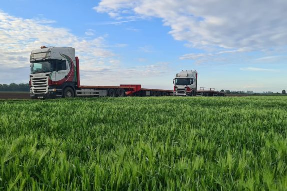 Two Glover lorries parked by the side next to fields